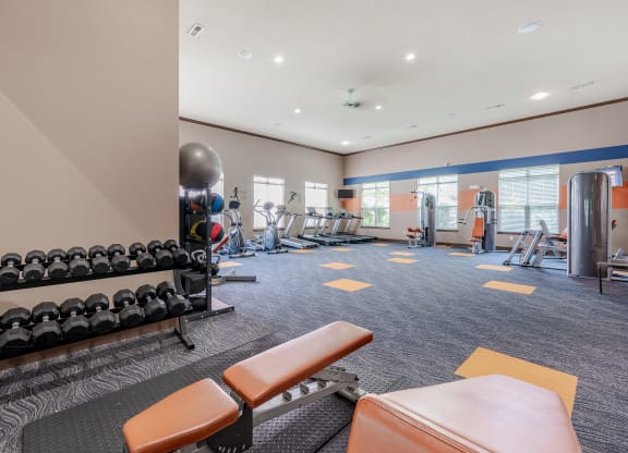 spacious gym with weights and cardio equipment at the reserve apartments