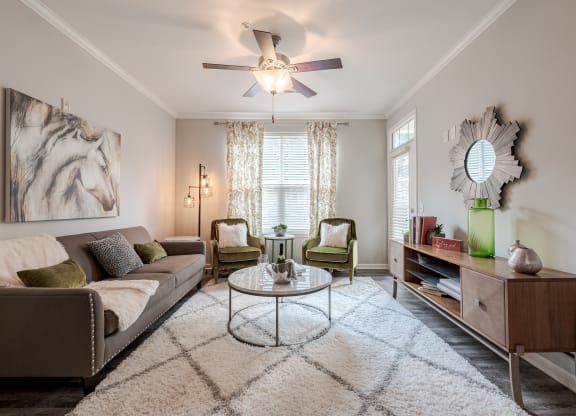 a living room with a ceiling fan and a couch