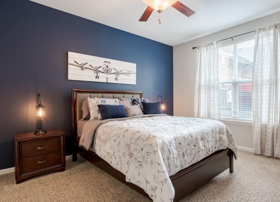 a bedroom with a bed and a ceiling fan