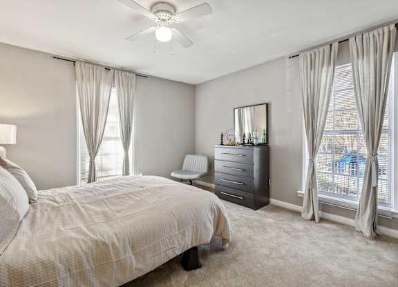 A bedroom with a large bed and a dresser.