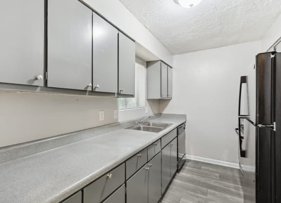 the kitchen of our studio apartment atrium with stainless steel appliances and white cabinets