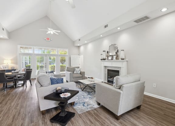 a living room with couches and chairs and a fireplace