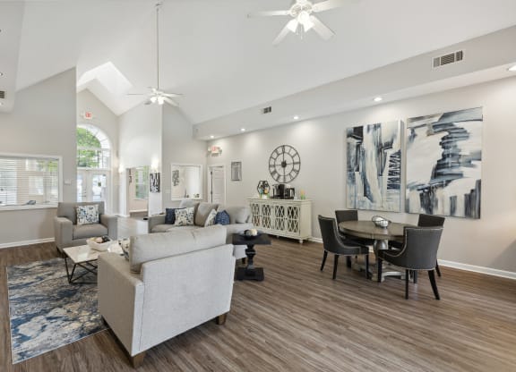 a living room with couches and chairs and a dining room table