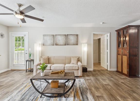 a living room with a couch and a ceiling fan