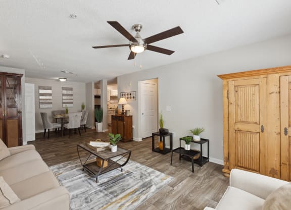 a living room with a couch and a ceiling fan