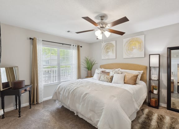 the preserve at ballantyne commons bedroom with ceiling fan and large bed