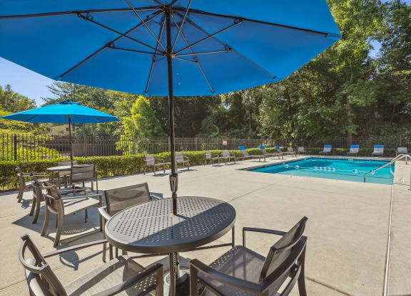 our apartments have a pool and a patio with chairs and tables