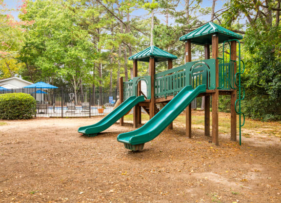 a playground with a slide at a park