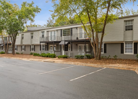 an empty parking lot in front of an apartment building