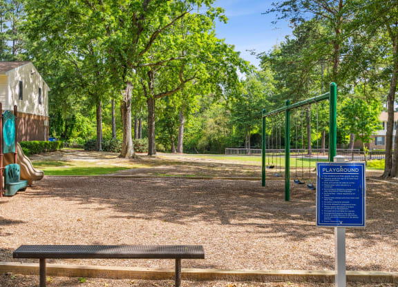 a park with a playground and a bench
