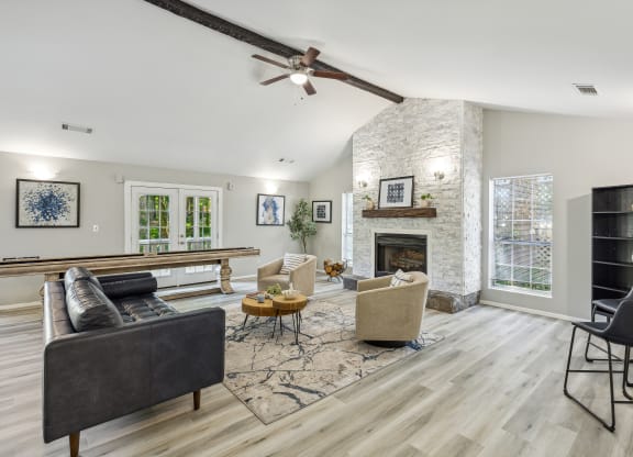 an open living room with a fireplace and a ceiling fan