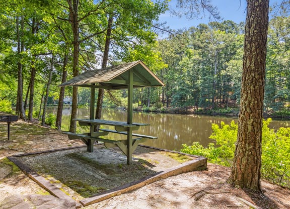 a picnic table next to a body of water