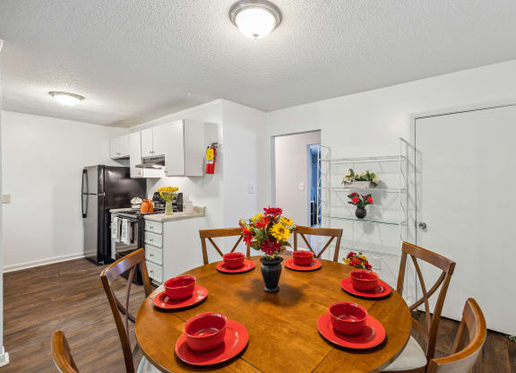 a kitchen and dining room with a table and chairs