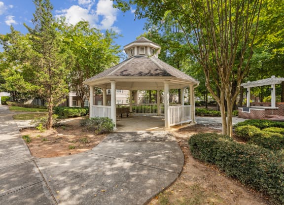 a gazebo in a park with trees