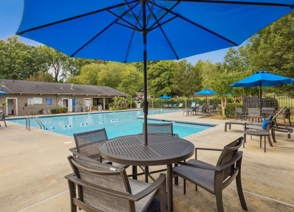 our apartments have a swimming pool and tables with umbrellas