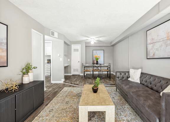 A living room with a grey couch and a coffee table.