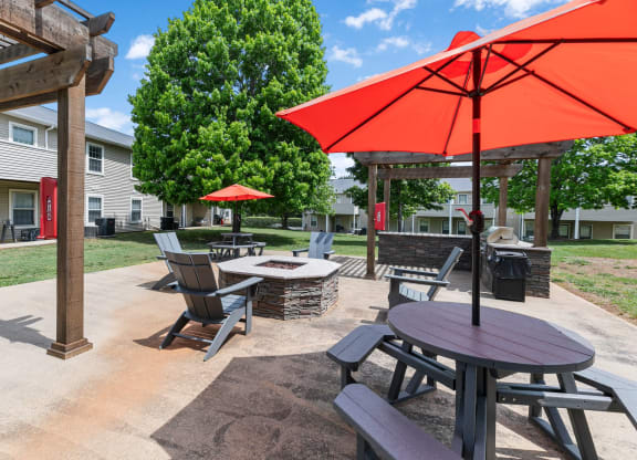 a patio with tables and chairs and umbrellas