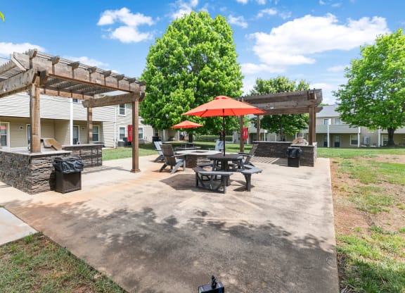 our apartments have a patio with picnic tables and umbrellas