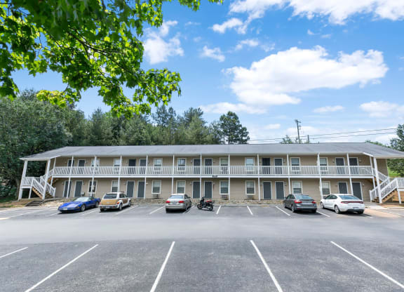 an office building with cars parked in the parking lot