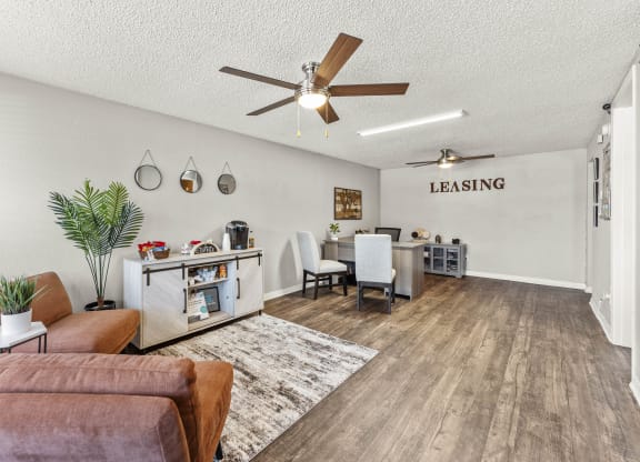 the living room and dining area of a house with a ceiling fan