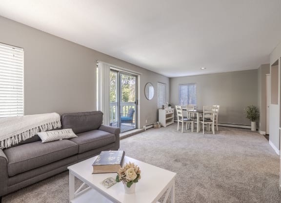 an open living room and dining room with a couch and a table
