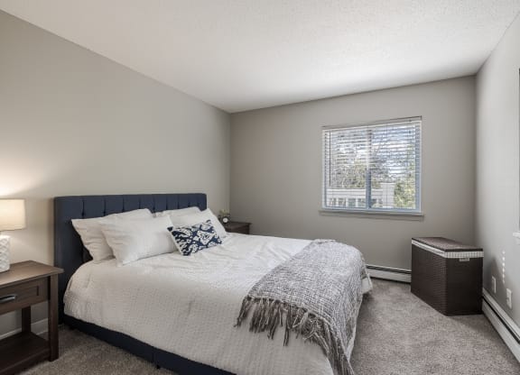 a bedroom with a large bed and a window