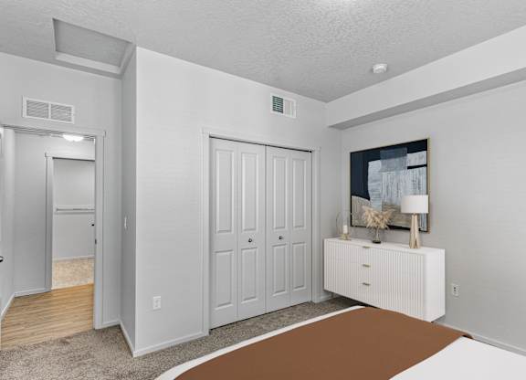 A room with a brown rug in the middle of the floor.