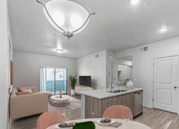 A well-lit kitchen and dining area with modern furniture.