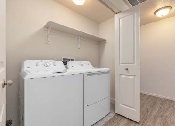 A white washer and dryer in a small laundry room.