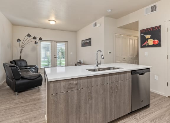 A kitchen with a sink and a chair.