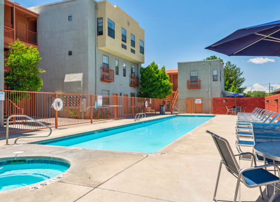 our apartments have a swimming pool with chairs and umbrellas