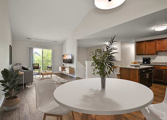 A white table with a plant on it in the middle of a room.