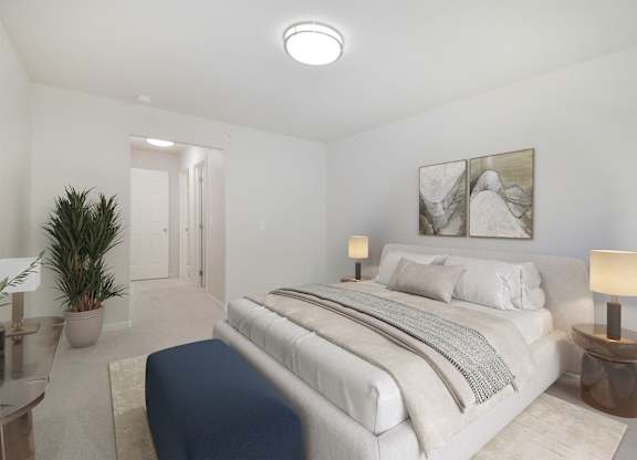 A bedroom with a large bed and a painting on the wall.