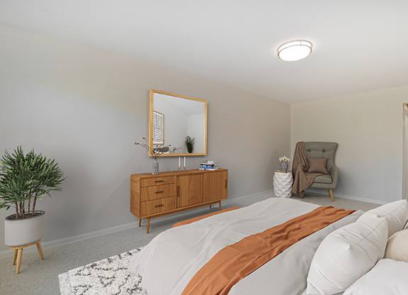 A bedroom with a bed, a dresser, a mirror, and a plant.