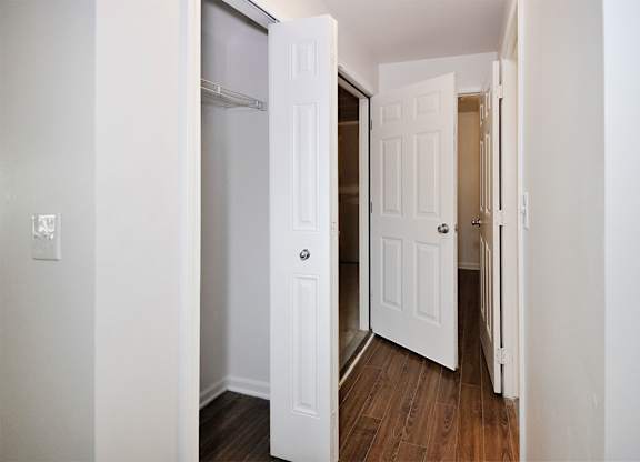A white door is open to a hallway.