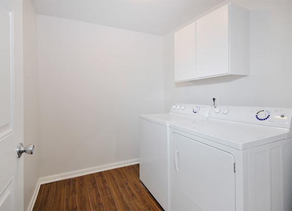 Laundry room with built-in storage and a washer and dryer.