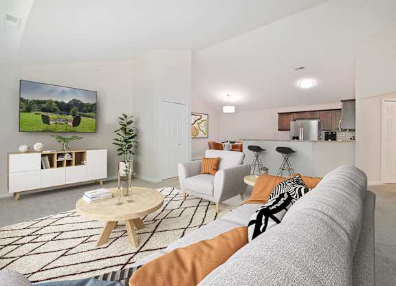 A living room with a grey couch and a wooden coffee table.