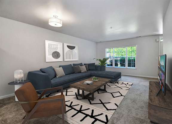 A living room with a blue couch, a coffee table, and a television.