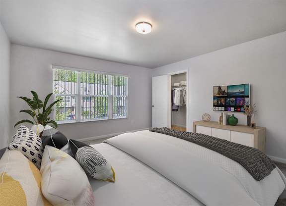 A bedroom with a large bed and a painting on the wall.