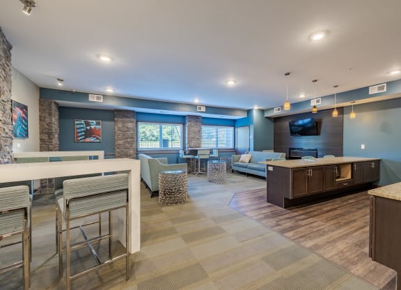 a living room and dining area with a couch and a tv