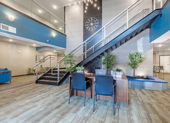 a dining room with a table and chairs under a staircase