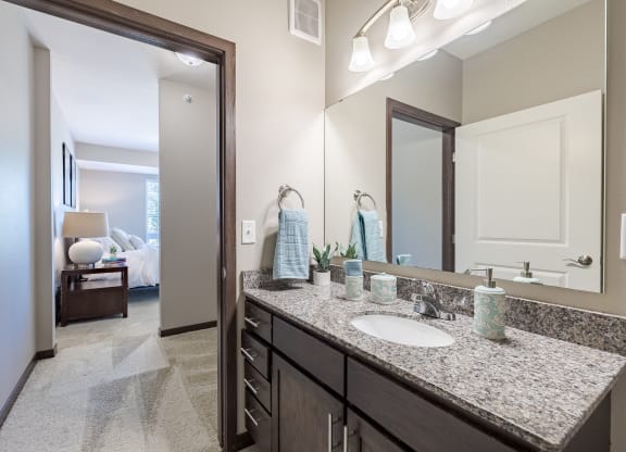an open bathroom with a sink and a mirror
