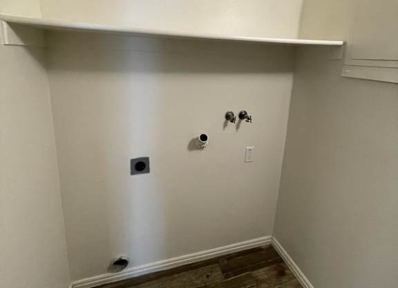 A white wall with a switch and a socket.