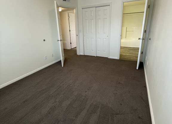 A room with a carpeted floor and white walls.