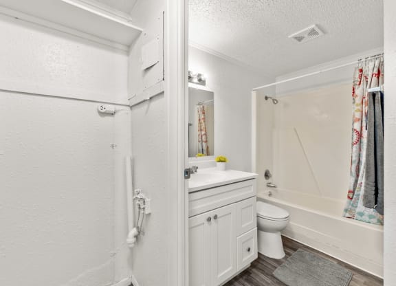 a bathroom with a sink toilet and a shower