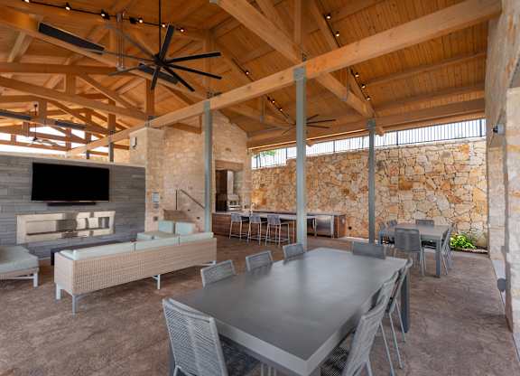A large room with a stone wall and a wooden ceiling.