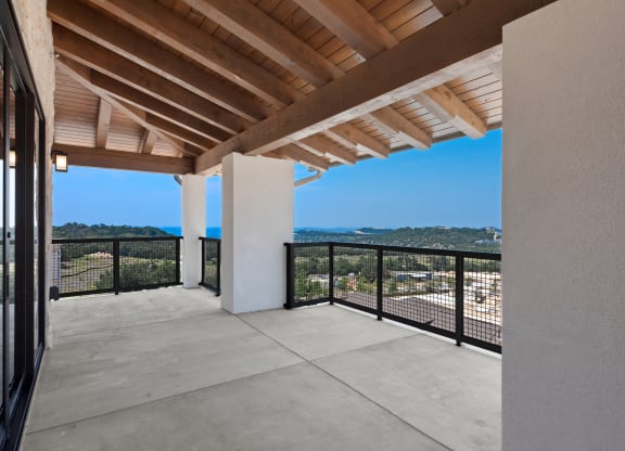 a balcony with a view of the city and the mountains