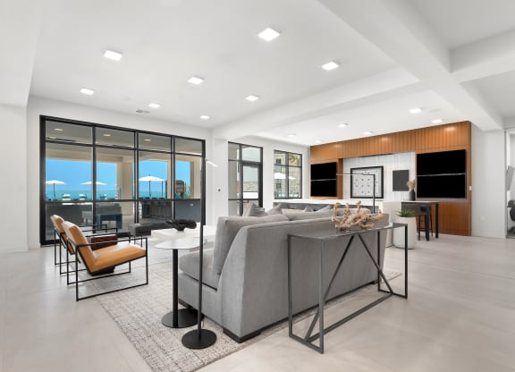 a large living room with a gray couch and a table