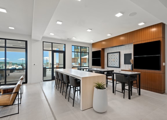 a communal area with a table and chairs in a modern office space