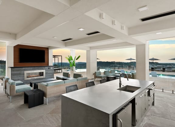 a large kitchen and living room with a view of a swimming pool